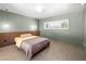 Inviting bedroom featuring wood paneling, neutral tones, and lots of natural light at 3212 Silver Saddle St, Las Vegas, NV 89169