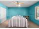 Bright bedroom showcases a ceiling fan, carpet floors, large closets, and unique blue walls at 3212 Silver Saddle St, Las Vegas, NV 89169