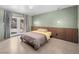 Cozy bedroom with wood accent wall, neutral tones, and access to the outdoors at 3212 Silver Saddle St, Las Vegas, NV 89169