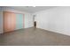 Bright bedroom with closet and doorway, featuring speckled flooring at 3212 Silver Saddle St, Las Vegas, NV 89169