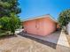Exterior side view of stucco home features desert landscaping and shade trees at 3212 Silver Saddle St, Las Vegas, NV 89169