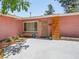 Charming single-story home with pink facade and wood detail front entrance at 3212 Silver Saddle St, Las Vegas, NV 89169