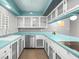 Bright kitchen featuring stainless steel appliances, glass front cabinets, and a turquoise countertop at 3212 Silver Saddle St, Las Vegas, NV 89169