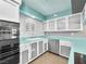 Kitchen with stainless steel appliances, glass front cabinets, and a turquoise countertop at 3212 Silver Saddle St, Las Vegas, NV 89169