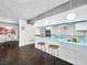 Bright, stylish kitchen featuring unique lighting, turquoise countertop, and stainless steel appliances at 3212 Silver Saddle St, Las Vegas, NV 89169