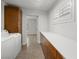 Well-lit laundry room with white washer and dryer, and ample counter space at 3212 Silver Saddle St, Las Vegas, NV 89169