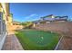 Private backyard featuring a putting green, brick patio and mature landscaping at 3213 Molinos Dr, Las Vegas, NV 89141