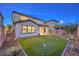 Serene backyard featuring a lush green putting green and thoughtfully designed landscaping at 3213 Molinos Dr, Las Vegas, NV 89141
