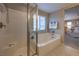 Bathroom with a glass shower and tub, along with a view into the main bedroom and light coming from the window at 3213 Molinos Dr, Las Vegas, NV 89141