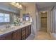 Bathroom featuring double sinks, stylish mirrors, and a separate glass-enclosed shower at 3213 Molinos Dr, Las Vegas, NV 89141