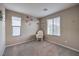 Cozy bedroom with plush carpet, two bright windows, floral wall decor and a rocking chair at 3213 Molinos Dr, Las Vegas, NV 89141