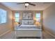 Calm bedroom with a queen bed, ceiling fan, and matching nightstands with decorative lamps at 3213 Molinos Dr, Las Vegas, NV 89141