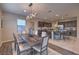 Bright dining area featuring modern chandelier lighting and an open view into the kitchen at 3213 Molinos Dr, Las Vegas, NV 89141