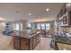 Modern kitchen with an open design, stainless steel appliances, and a large island connecting to the dining area at 3213 Molinos Dr, Las Vegas, NV 89141