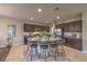 Spacious kitchen with dark cabinetry, granite countertops, stainless steel appliances, and a large island with seating at 3213 Molinos Dr, Las Vegas, NV 89141