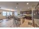 An open-concept kitchen features a large island with bar seating, granite countertops, and dark wood cabinetry at 3213 Molinos Dr, Las Vegas, NV 89141