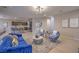 Stylish living room with modern blue furniture, neutral walls, and an open layout to the kitchen at 3213 Molinos Dr, Las Vegas, NV 89141