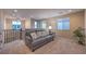Cozy loft area with a comfortable sofa, soft carpet, and natural light from the large windows at 3213 Molinos Dr, Las Vegas, NV 89141