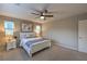 Spacious main bedroom with a ceiling fan and a view of neighborhood homes through the window at 3213 Molinos Dr, Las Vegas, NV 89141