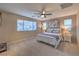 Bright main bedroom features a ceiling fan, two windows, and neutral decor at 3213 Molinos Dr, Las Vegas, NV 89141