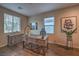 Cozy office space with wood-look floors, a rustic desk, and natural light from two windows at 3213 Molinos Dr, Las Vegas, NV 89141
