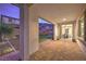 Covered patio featuring brick flooring, views of putting green and backyard at 3213 Molinos Dr, Las Vegas, NV 89141