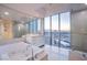 Bathroom boasts a large tub, stand-up shower, and a window overlooking the cityscape at 322 Karen Ave # 3801, Las Vegas, NV 89109