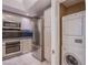 Kitchenette features stainless steel appliances and stacked washer and dryer at 322 Karen Ave # 3801, Las Vegas, NV 89109
