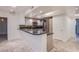 Open concept kitchen with breakfast bar, stainless steel appliances, and tile flooring at 322 Karen Ave # 3801, Las Vegas, NV 89109