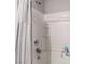Close-up of a shower-tub combination with tile surround and a shower curtain at 3221 Pergusa Dr, Henderson, NV 89044