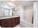Bathroom with double sink vanity, large mirror, and shower-tub combination with tiled walls at 3221 Pergusa Dr, Henderson, NV 89044