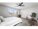 This bedroom features carpet, natural light from three windows, a full length mirror, and a chair at 3221 Pergusa Dr, Henderson, NV 89044