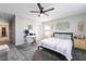 This cozy bedroom features carpet, a ceiling fan, a desk and chair, and decorative wall hangings at 3221 Pergusa Dr, Henderson, NV 89044