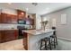 Beautiful kitchen with dark wood cabinets, granite countertops, and stainless steel appliances at 3221 Pergusa Dr, Henderson, NV 89044