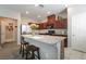 Bright kitchen featuring an island with seating, granite countertops, and modern appliances at 3221 Pergusa Dr, Henderson, NV 89044