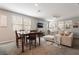 Bright living room with a dining area, featuring a plush sofa, large windows, and stylish decor at 3221 Pergusa Dr, Henderson, NV 89044