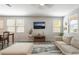 Bright living room featuring a plush sofa, large windows, and stylish decor at 3221 Pergusa Dr, Henderson, NV 89044