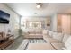 Bright living room featuring a plush sofa, large windows, and stylish decor at 3221 Pergusa Dr, Henderson, NV 89044