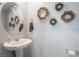 Stylish powder room with a vessel sink and decorative wall art at 3221 Pergusa Dr, Henderson, NV 89044