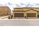 Townhome featuring private garage, desert landscaping, and tile roof details at 3270 Palindrome Ave, Henderson, NV 89044