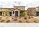 Charming two-story home with stone accents and desert landscaping, steps up to the front door at 3270 Palindrome Ave, Henderson, NV 89044