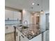 Close-up of island with black granite and view of stainless steel dishwasher at 3270 Palindrome Ave, Henderson, NV 89044