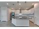 Kitchen with stainless steel appliances, white cabinets, and large island at 3270 Palindrome Ave, Henderson, NV 89044