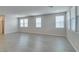 Large open space with modern gray flooring, bright walls, and ample natural light from the windows at 3270 Palindrome Ave, Henderson, NV 89044