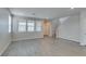 Bright, open living room with gray flooring, staircase, recessed lighting, and large windows at 3270 Palindrome Ave, Henderson, NV 89044