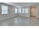 Bright living room with lots of windows, gray floors, recessed lighting, and white trim at 3270 Palindrome Ave, Henderson, NV 89044