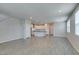 Bright living space with open floor plan to the kitchen; modern gray flooring and recessed lighting at 3270 Palindrome Ave, Henderson, NV 89044