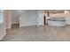 Open-concept living area with stairs, view to the kitchen, gray flooring, and light gray walls at 3270 Palindrome Ave, Henderson, NV 89044