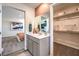 Bathroom vanity featuring a large mirror and access to the main bedroom and walk-in closet at 3389 La Cura Ave # Lot 43, Las Vegas, NV 89141