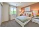 Cozy bedroom featuring a comfortable bed, bedside tables, and a large window with a scenic view at 3389 La Cura Ave # Lot 43, Las Vegas, NV 89141